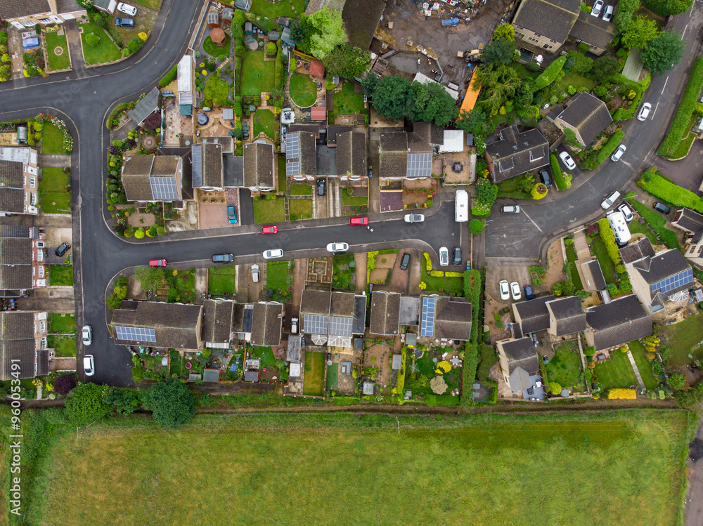 Aerial photo of the UK town of Worsbrough in Barnsley South Yorkshire, England showing rows of houses, roads and a typical British housing estates on a sunny day