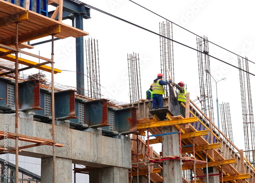 Workers Engaged In Construction Activities On Concrete Structure