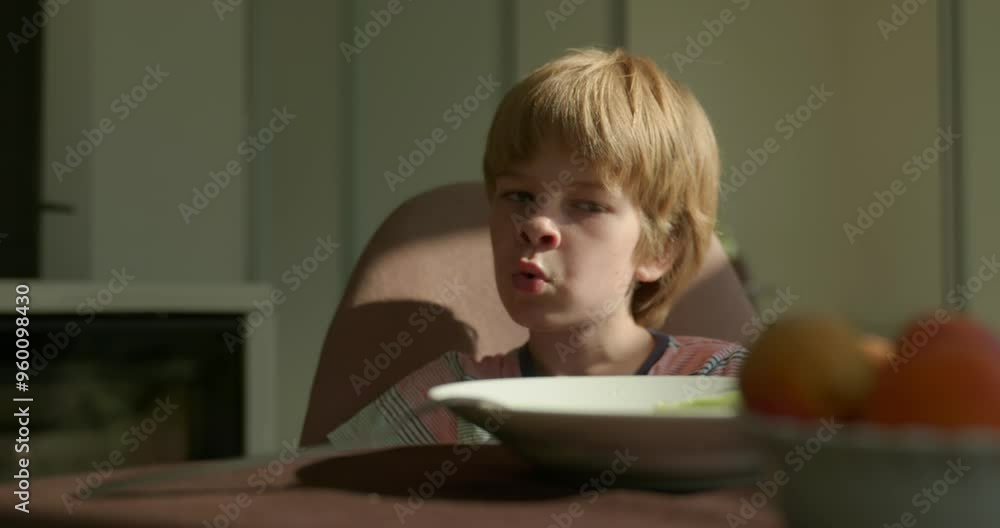Satisfied Kid Boy Sits Singing After Breakfast or Dinner. Slow motion 60fps 4K 10-bit Satisfied Kid Boy Sits Singing After Breakfast or Dinner. Slow motion 60fps 4K 10-bit