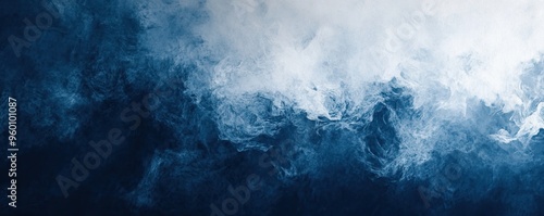 An abstract image of dark blue smoke blending with white fog, creating a captivating and mysterious atmosphere.