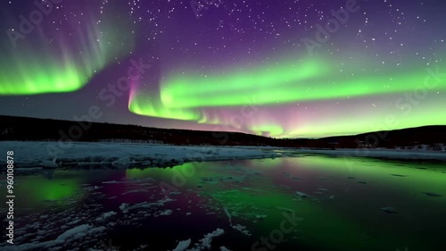 Wallpaper Mural A breathtaking shot of the Northern Lights reflecting on the surface of a frozen lake, creating a mirror effect of vibrant colors.
 Torontodigital.ca