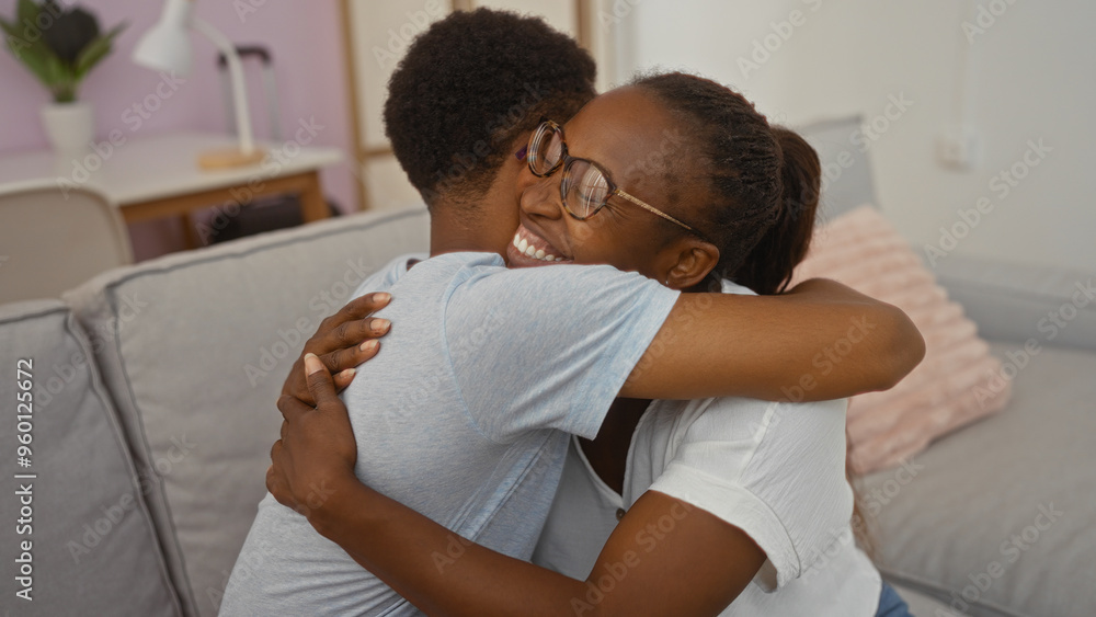 Mother and son sharing a loving embrace in the living room of their home displaying the warmth of family togetherness Mother and son sharing a loving embrace in the living room of their home displaying the warmth of family togetherness