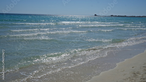 Idyllic beach scene in porto cesareo, italy, showcasing salento's clear blue water and sandy shore under a bright summer sky. photo