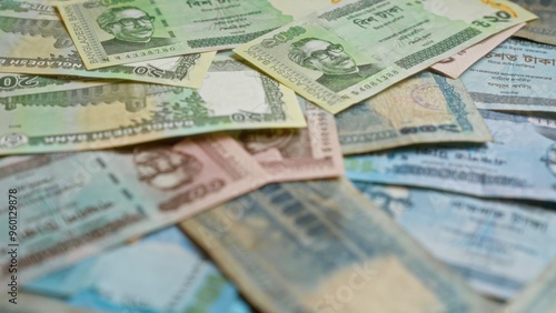 Fotografie Bangladeshi taka banknotes displayed in a scattered arrangement highlighting the diverse currency of bangladesh