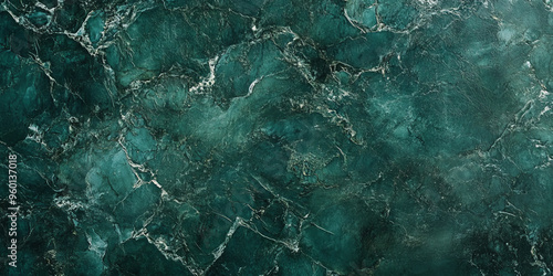 A dark green textured surface with a fine, grainy texture, similar to the surface of dark, weathered marble. photo