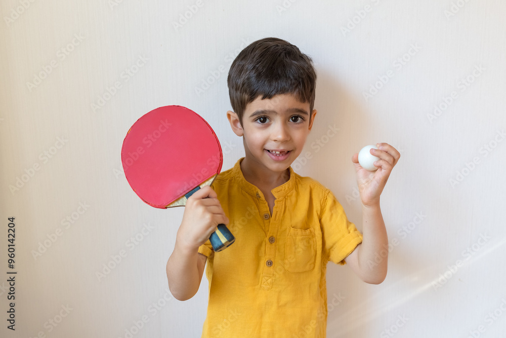 Boy plays ping pong isolated on white background. Child with table tennis racket. Sports concept Boy plays ping pong isolated on white background. Child with table tennis racket. Sports concept