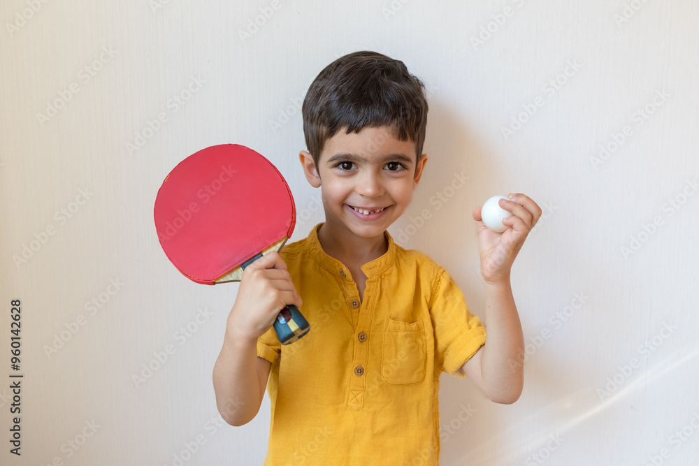 Boy plays ping pong isolated on white background. Child with table tennis racket. Sports concept Boy plays ping pong isolated on white background. Child with table tennis racket. Sports concept