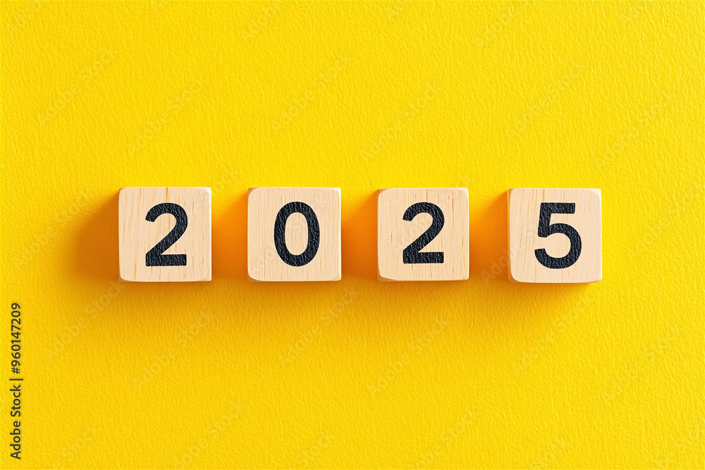 Four wooden cubes on a yellow surface show 2025, leaving space for your message. Represents time, change, and new year anticipation. Welcome 2025 with optimism! Four wooden cubes on a yellow surface show 2025, leaving space for your message. Represents time, change, and new year anticipation. Welcome 2025 with optimism!