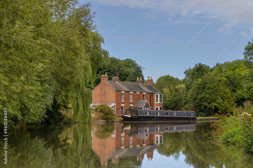 Narrowboat moored in front of country house Narrowboat moored in front of country house