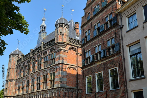 Traditional historic medieval houses and on the left Museum De Waag (Weighing House), located in the city center of Deventer, Overijssel, Netherlands. De Waag hosts the History Museum of the city