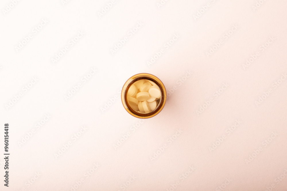 Pills. Medicines in jar on pink background top wiev. Medicine dose. Concept of medicinal treatment, vitamins, antibiotic, supplements, contraceptive pills. Womens health banner. High quality photo Pills. Medicines in jar on pink background top wiev. Medicine dose. Concept of medicinal treatment, vitamins, antibiotic, supplements, contraceptive pills. Womens health banner. High quality photo