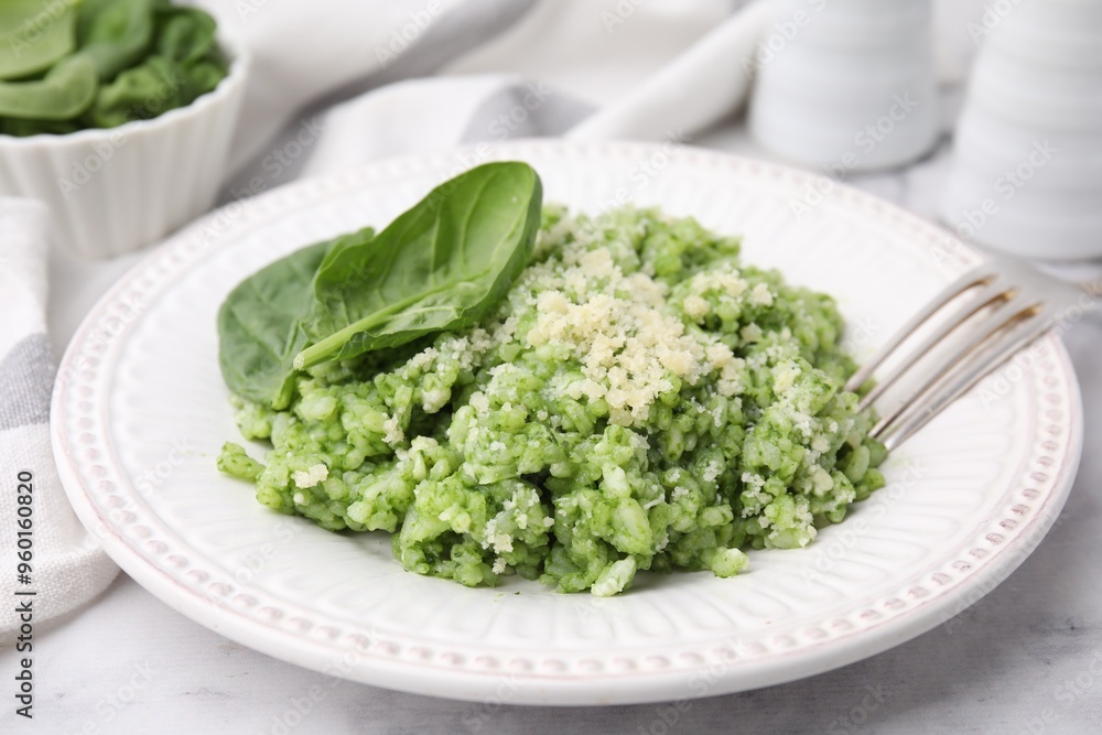 Tasty spinach risotto served on white marble table, closeup Tasty spinach risotto served on white marble table, closeup