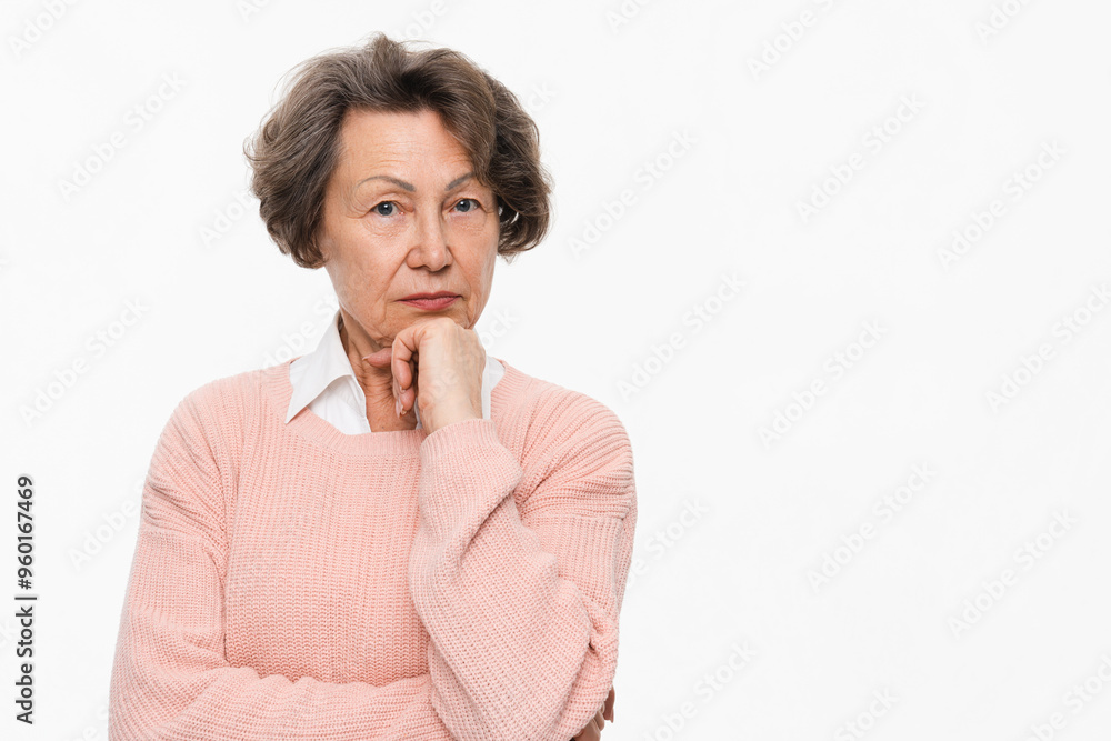 Pensive old woman in casual clothes thinking about pension and income isolated over white background. Senior Caucasian lady being in thoughtful mood about health issues Pensive old woman in casual clothes thinking about pension and income isolated over white background. Senior Caucasian lady being in thoughtful mood about health issues