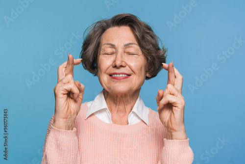 Принти на полотні Hopeful happy old aged elderly woman female pensioner crossing fingers hoping fo