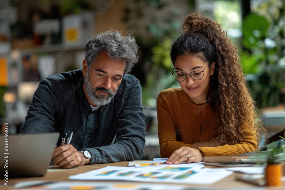 Male and Female Colleagues Collaborating as Equals on a Project in a Modern Office Setting Male and Female Colleagues Collaborating as Equals on a Project in a Modern Office Setting