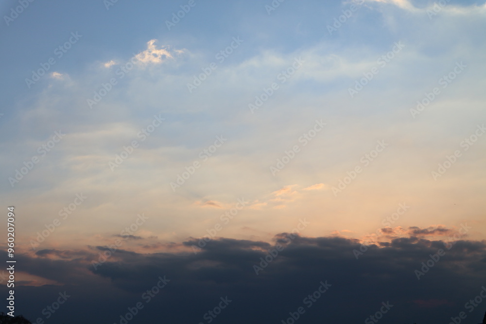 Evening sky has dark clouds and sunlight.