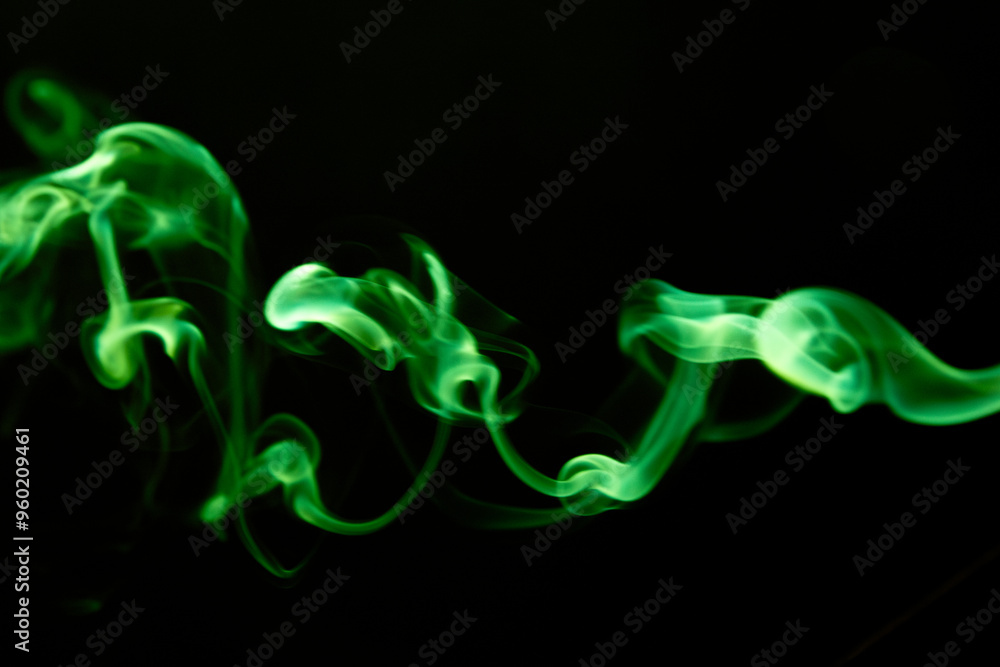 Fototapeta premium Illustration of green beautiful smoke on the black background 