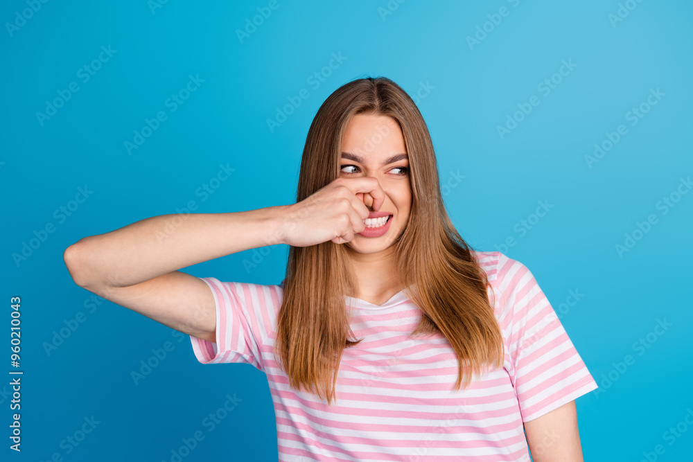 Photo of pretty cute funny woman wear stylish pink clothes look empty space isolated on blue color background Photo of pretty cute funny woman wear stylish pink clothes look empty space isolated on blue color background