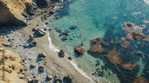 Aerial view of Glass Beach with the sea glass glittering against the rugged rocks.