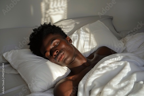 A beautiful black man sleeps on a white pillow covered with a white blanket. The rays of dawn illuminate his face. AI generative