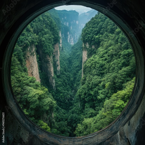 The panoramic view from the top of the Bailong Elevator in Zhangjiajie, looking down on the lush forest and towering cliffs. photo