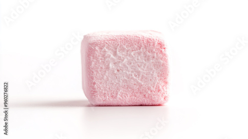 A single pink marshmallow stands on a white surface, showcasing its fluffy texture in natural light during a bright afternoon