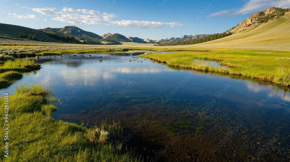 The serene Lamar River in Yellowstone with wildlife drinking from its banks and mountains beyond. The serene Lamar River in Yellowstone with wildlife drinking from its banks and mountains beyond.