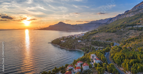 Fototapeta Naklejka Na Ścianę i Meble -  Stanici village with main beach against sunset over the sea near the Omis in Croatia