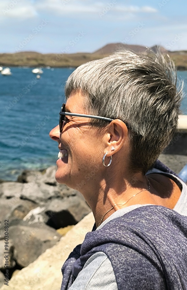 Close up profile of happy young adult woman,looking at the view on a beautiful sunny day at the seaside.Smiling girl in profile looking at the sea.Caucasian woman in profile amused looking Close up profile of happy young adult woman,looking at the view on a beautiful sunny day at the seaside.Smiling girl in profile looking at the sea.Caucasian woman in profile amused looking