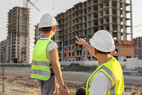 Dad shows his son their new apartment in a building under construction.
