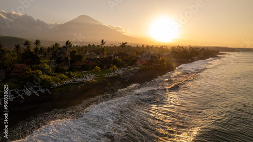 Amed beach in east Bali, popular diving and snorkeling tourist destination with majestic Agung Volcano in the background during sunset, Indonesia.