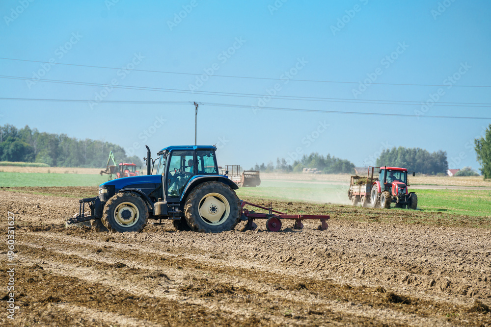 Obraz premium A tractor plowing a field