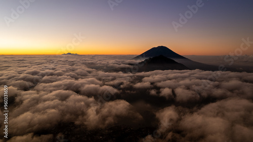 Epic sunrise over the clouds with the view of the Agung volcano at Bali, Indonesia and the view of mount Rinjani from the island of Lombok in the background 