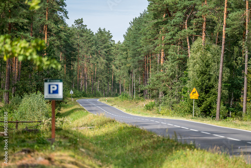 Fototapeta Naklejka Na Ścianę i Meble -  An asphalt scenic road going through a forest in Masuria