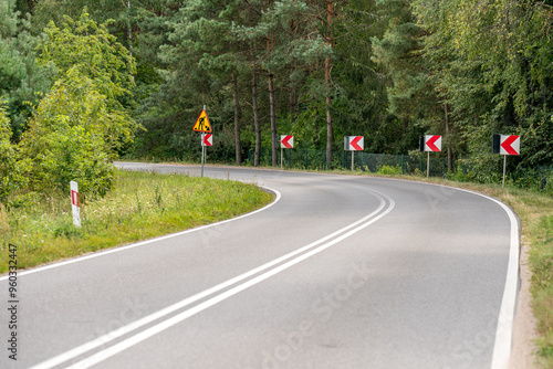 Fototapeta Naklejka Na Ścianę i Meble -  A sharp turn of an asphalt road in Masuria