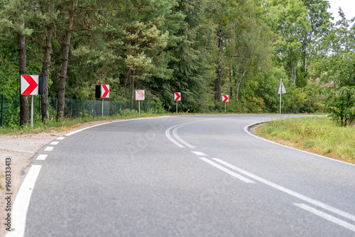 Fototapeta Naklejka Na Ścianę i Meble -  A sharp turn of an asphalt road in Masuria