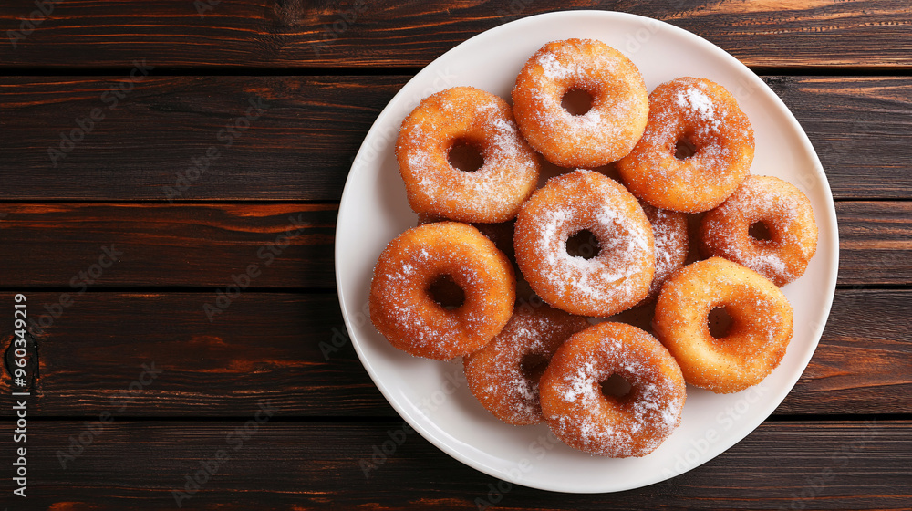 Delicious powdered sugar-covered donuts on a rustic wooden table Delicious powdered sugar-covered donuts on a rustic wooden table