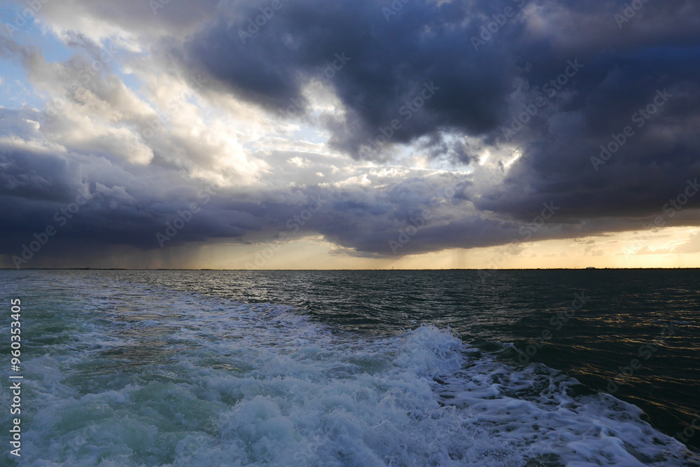 Sunset over ocean in Cancun, behind boat Sunset over ocean in Cancun, behind boat