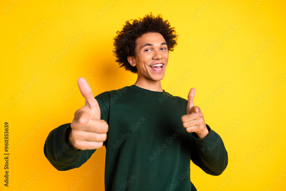 Portrait of nice young man point fingers you wear sweater isolated on yellow color background Portrait of nice young man point fingers you wear sweater isolated on yellow color background