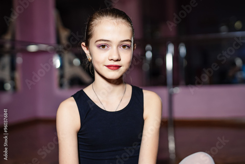 Young dancer in black outfit poses confidently at studio rehearsal. A young dancer sits in a rehearsal studio Free Download Young dancer in black outfit poses confidently at studio rehearsal. A young dancer sits in a rehearsal studio - GFXLoad