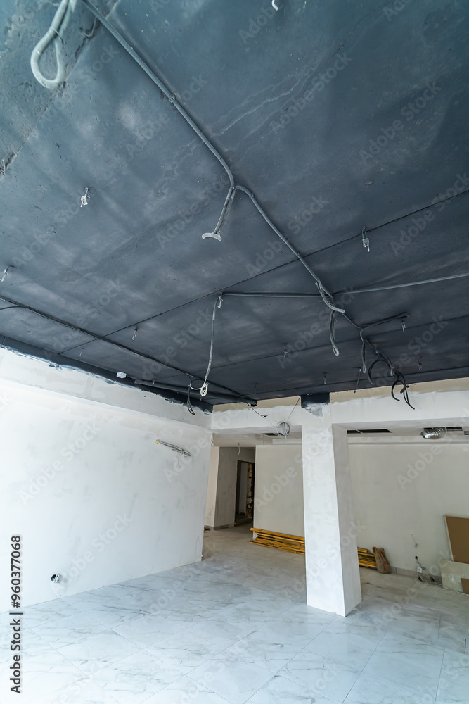 Newly renovated commercial space with exposed ceilings in daylight. A modern commercial space features exposed ceilings and bright lighting Newly renovated commercial space with exposed ceilings in daylight. A modern commercial space features exposed ceilings and bright lighting