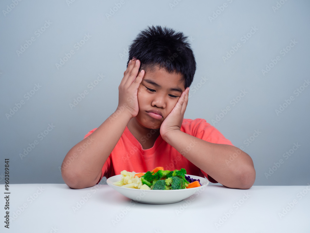 Children do not like to eat vegetables, Little cute boy refuses to eat healthy vegetables, Nutrition healthy eating habits for kids concept, Children do not like to eat vegetables. Children do not like to eat vegetables, Little cute boy refuses to eat healthy vegetables, Nutrition healthy eating habits for kids concept, Children do not like to eat vegetables.