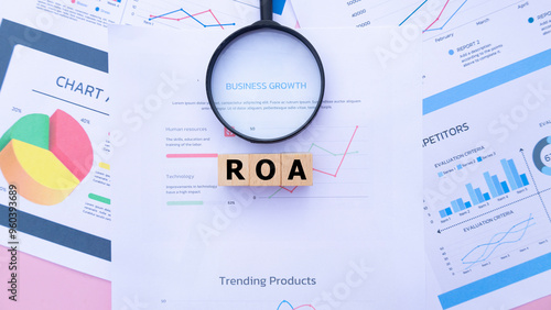 Three wooden cubes with the word ROA on graph sheets, abbreviation for Return on Assets. Business profitability analysis, growth success, profitability. Business and financial market concepts.