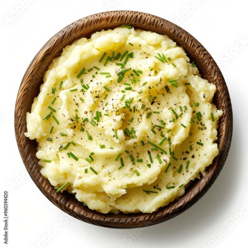 A bowl of creamy mashed potatoes with chives and pepper. photo