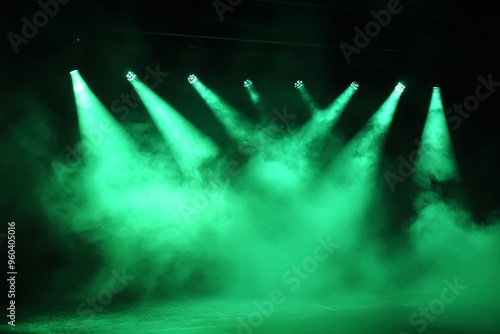 Illuminated stage with green spotlight and smoke creating a dramatic atmosphere at night