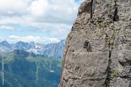 Via Ferrata delle Trincee, Dolomites, Val di Fassa Valley. Man climbing the vertical rocky mountain.