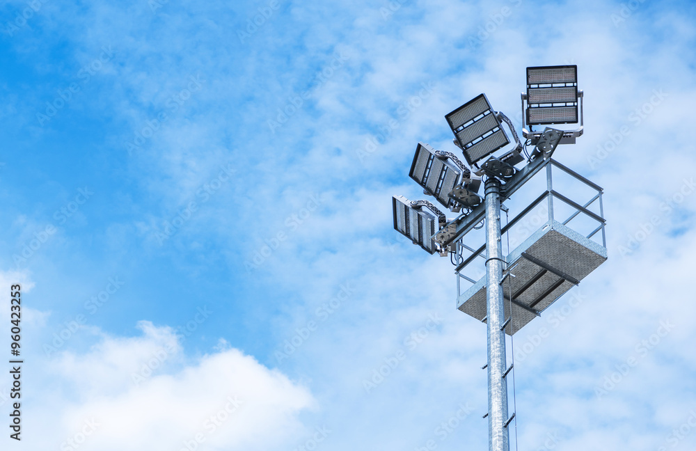 Bright Lighting Tower Stands Tall Against a Clear Blue Sky During the Day at an Outdoor Venue Bright Lighting Tower Stands Tall Against a Clear Blue Sky During the Day at an Outdoor Venue