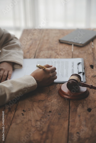 Business and lawyers discussing contract papers with brass scale on desk in office. Law, legal services, advice, justice and law concept picture with film grain effect