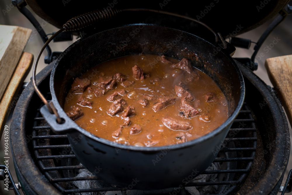 ready to eat - goulash from venison meat, from a roebuck - cooked in a dutch oven on a charcoal grill at outdoor ready to eat - goulash from venison meat, from a roebuck - cooked in a dutch oven on a charcoal grill at outdoor