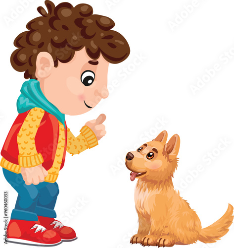 Young boy training his puppy dog by pointing with his finger